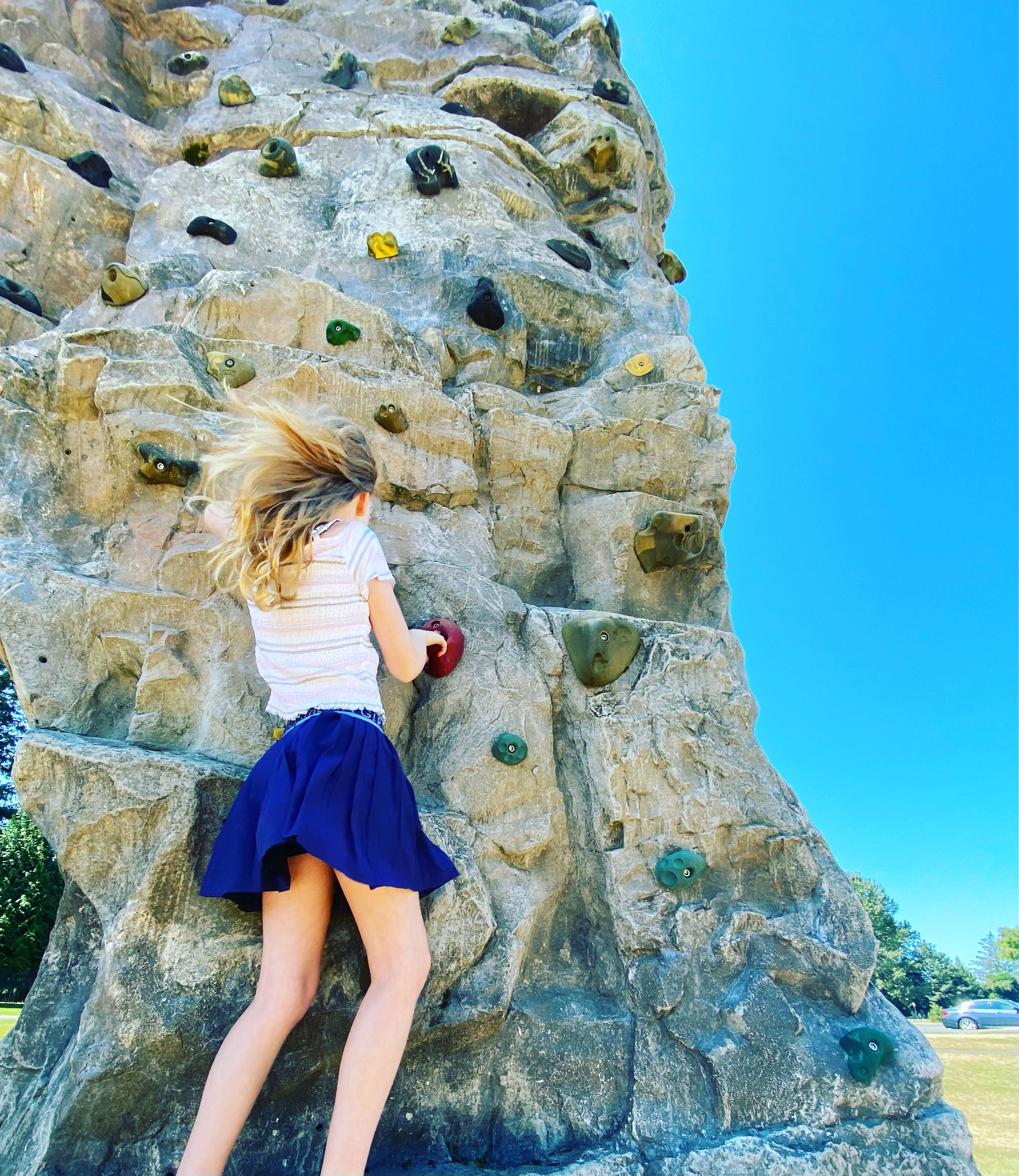 A child climbing a climbing wall